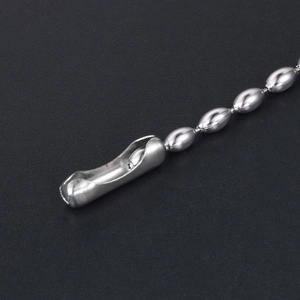 Polished silver stainless steel ball bead chain with cylinder connector on black background