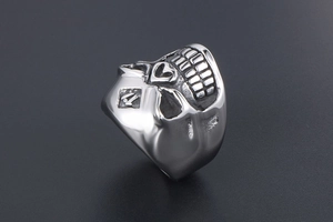 Macro shot of punk style stainless steel skull ring featuring engraved diamond 11 icon