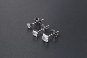 Detailed view of three sizes of square zircon stud earrings with classic 4-prong setting
