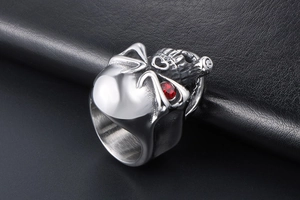 Macro shot of punk skull ring with red rhinestone eye and silver stainless steel finish