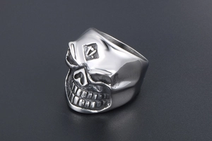 Detailed view of vintage silver skull ring featuring 1% embossed lettering on forehead