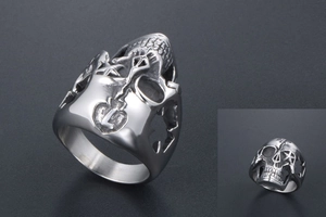 Detailed macro view of vintage stainless steel skull ring with engraved heart pattern
