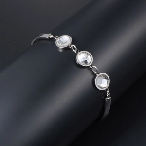 Modern silver titanium steel bracelet with three clear sparkling zircons on a black display