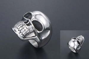 Detailed close-up of retro silver skull ring with gothic punk steel texture and vintage finish