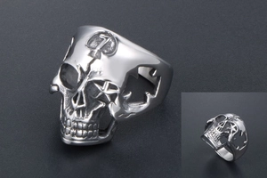 Macro view of skull ring featuring star cut-outs and hammer engraving on forehead
