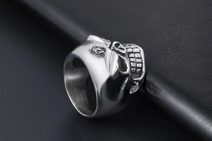 Macro side view of vintage silver skull ring with number 13 engraving on black leather