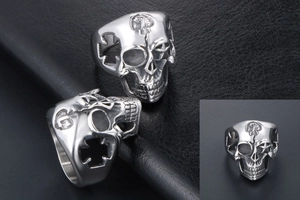 Detailed close-up of punk hollow skull ring with star and cross patterns on dark leather