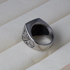 Macro shot of retro men's titanium steel ring with intricate side engraving details