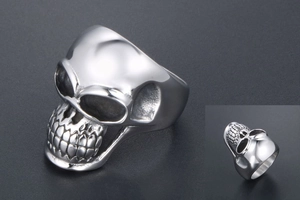 Macro view of polished stainless steel punk skull ring with detailed gothic engraving