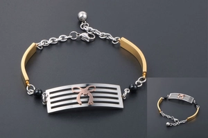 Close-up of tricolor stainless steel bracelet featuring a rose gold bow and black beads
