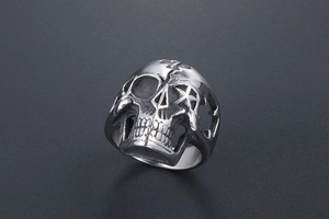 Detail of silver skull ring featuring hollow star cutouts and gothic punk metal texture