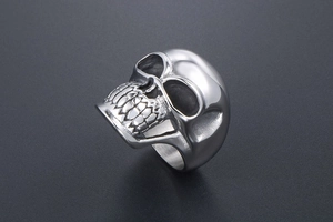 Macro shot of punk style stainless steel skull ring with realistic bone carving detail