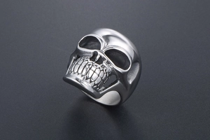 Detailed view of punk skull ring with polished silver metallic finish and realistic textures