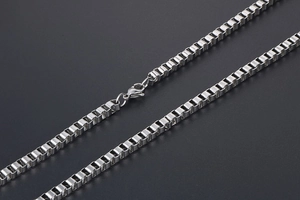 Close-up of silver steel box chain necklace featuring a durable lobster clasp detail