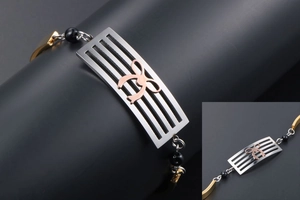 Macro view of multi-color metal bracelet showing rose gold bow on silver stainless plate