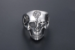 Detail of silver skull ring with number seven relief and hollow cross design