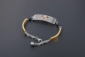 Detail of multi-color bracelet with rose gold bow, silver plate and black beads