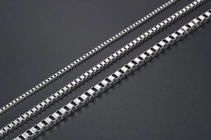 Macro shot of silver stainless steel box chains in three different widths for necklaces