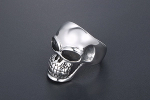 Macro shot of polished silver skull ring made of stainless steel with gothic punk details