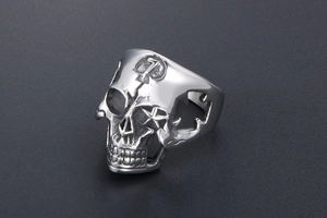 Macro shot of a punk skull ring in silver steel with a hammer and sickle emblem