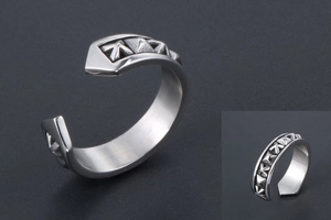 Macro shot of silver open ring featuring vintage geometric star carvings and industrial style