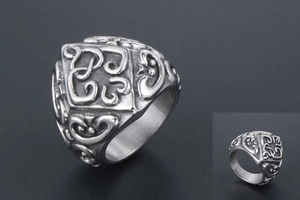 Detailed macro view of vintage wide titanium steel ring with intricate embossed patterns