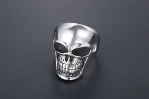 Detailed view of punk style stainless steel skull ring with vintage silver finish