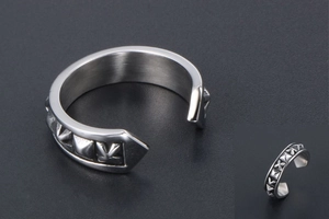 Detail shot of vintage silver rivet open ring featuring punk style embossed metal texture