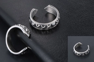 Detail of silver open ring featuring punk style pyramid stud rivet decorations