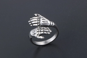 Macro shot of vintage titanium steel ring featuring realistic double skull hands design