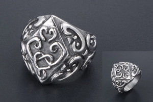Detailed macro view of vintage silver steel ring with hollow heart patterns and engraving