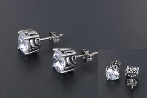 Detailed macro view of vintage gothic style earrings with clear zircon stones set in steel