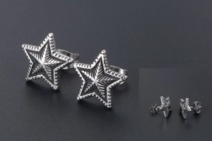 Detailed macro view of vintage silver star stud earrings with radial textured finish