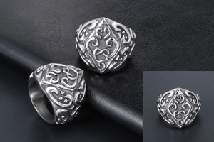 Detail of vintage punk wide band ring with intricate floral engravings on black leather