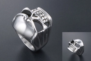 Detailed macro view of polished skull ring showing intricate stainless steel carving