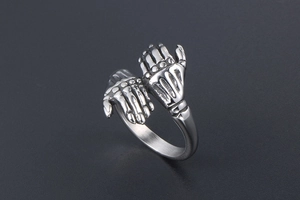 Detail view of vintage gothic silver double skull hand ring made of titanium steel