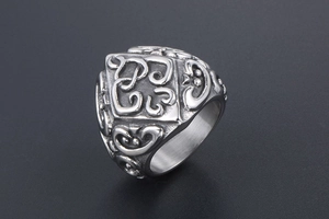 Macro shot of vintage style men's stainless steel ring with intricate embossed patterns