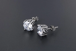 Macro shot of silver retro stud earrings featuring large round cubic zirconia and carvings