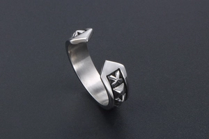 Detailed view of vintage open ring with arrow ends and cross star embossed texture