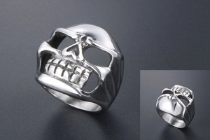 Macro shot of stainless steel skull ring with hollow eyes and vintage polished finish