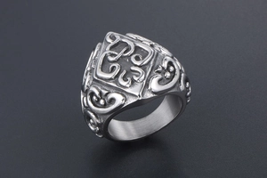 Macro detail of silver titanium steel ring with intricate vintage filigree embossing