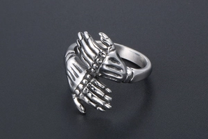 Detailed macro view of retro punk skeleton hands embracing in polished titanium steel