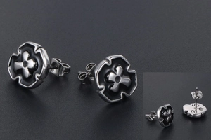 Detailed macro view of mens cross stud earrings showing the silver and black enamel finish