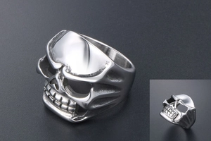 Detailed view of wide stainless steel ring featuring a realistic silver skull relief