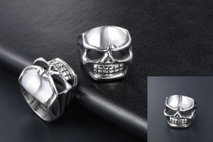 Macro shot of polished stainless steel skull rings featuring gothic punk style details