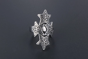 Macro shot of the stacked hollow star design and silver metallic texture on the ring