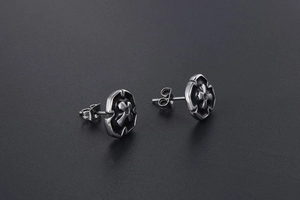 Detail of cross stud earrings for men in oxidized titanium steel with gothic pattern