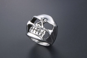 Macro detail of gothic skull ring in polished stainless steel with hollow eye sockets