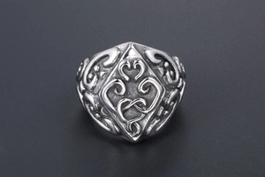 Macro shot of retro tribal relief patterns on vintage silver steel ring surface
