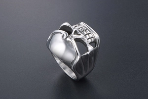 Macro detail of gothic skull ring in stainless steel with realistic hollow carving